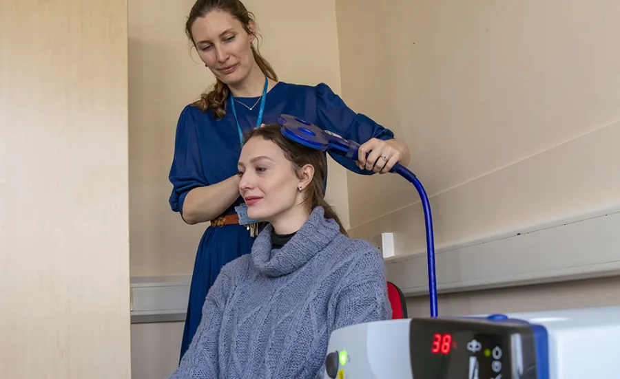 A person using neurostimulation lab equipment