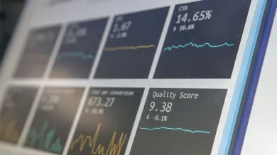 Business analytics visible in foreground of angled computer screen