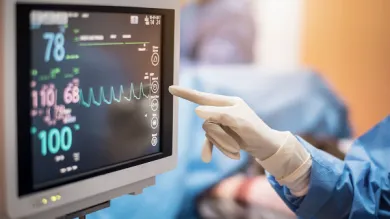 A surgeon monitoring a screen.