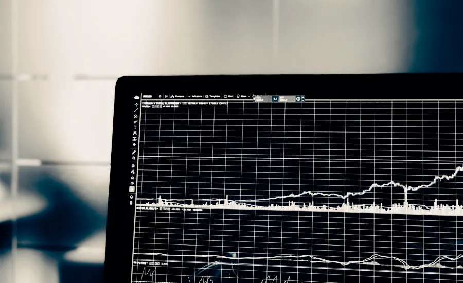 A laptop displaying a graph.