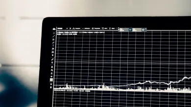 A laptop displaying a graph.