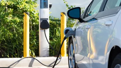 An electric car refuels at a charging point