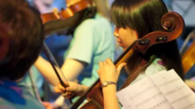 A student playing cello as part of the Southampton University Symphony Orchestra.