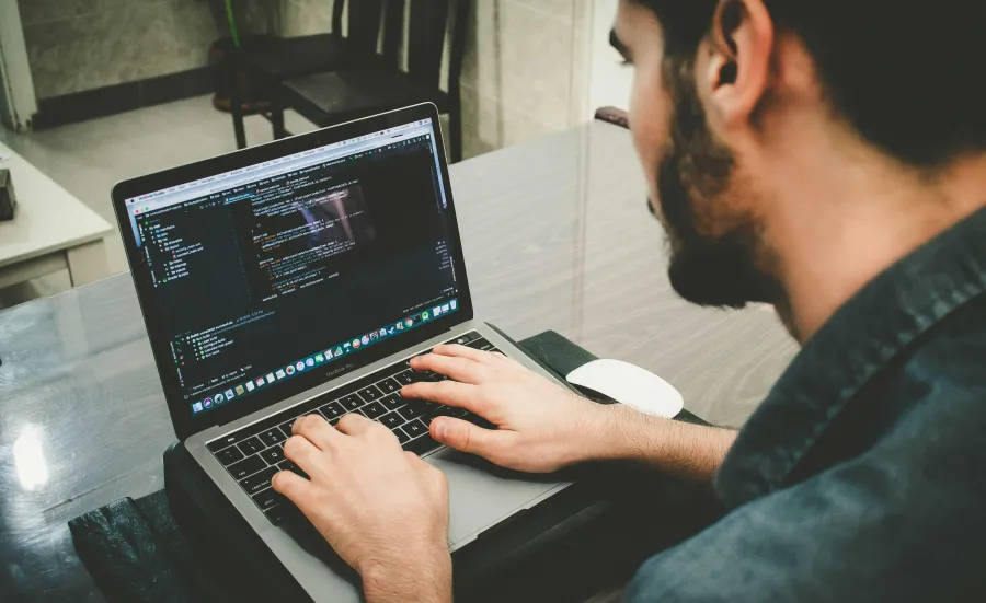 A person coding on their computer