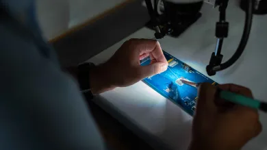 Person working on a circuit board
