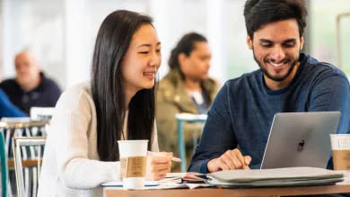 Students working together at a laptop