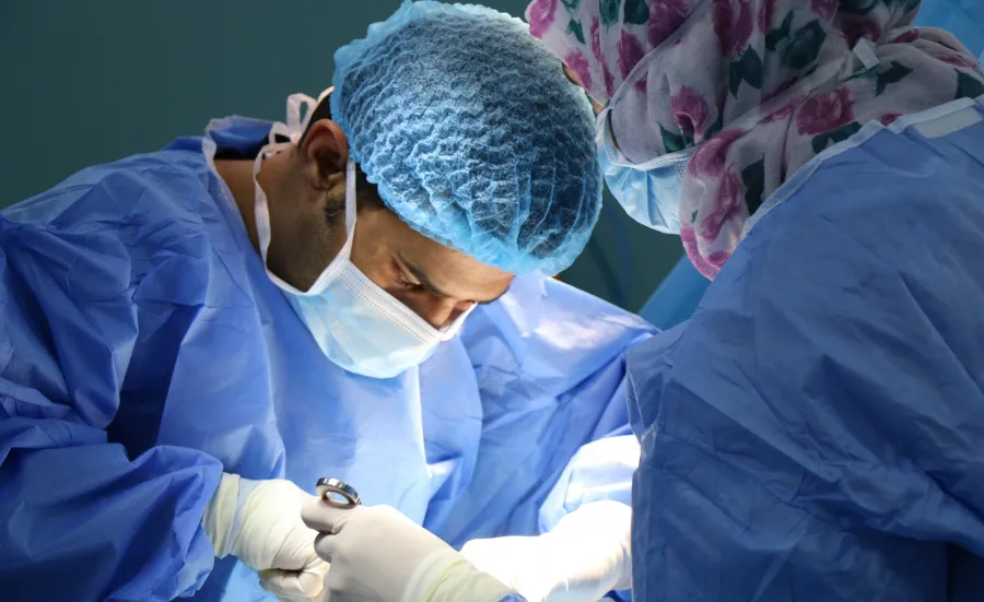 Image of two surgeons performing surgery. 