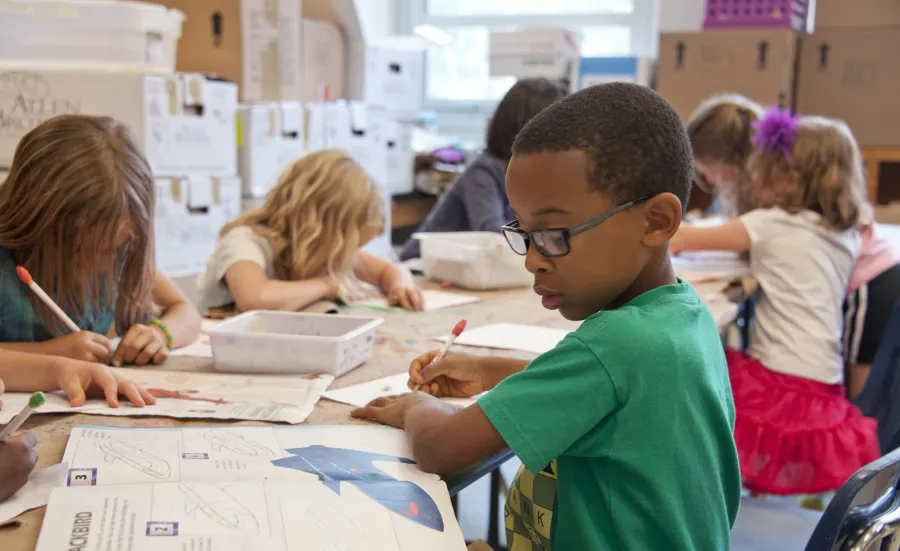 young children drawing and writing and school