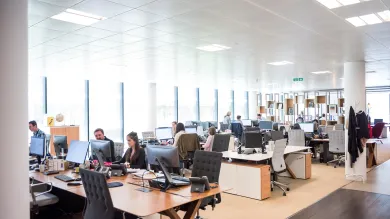 Image showing people working in a large office space.
