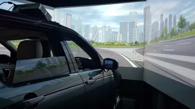 The exterior of a Land Rover driving simulator with screens showing a panoramic view