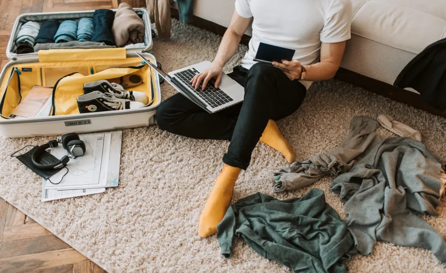 An international student packs their bag, including their passport, to come to the UK