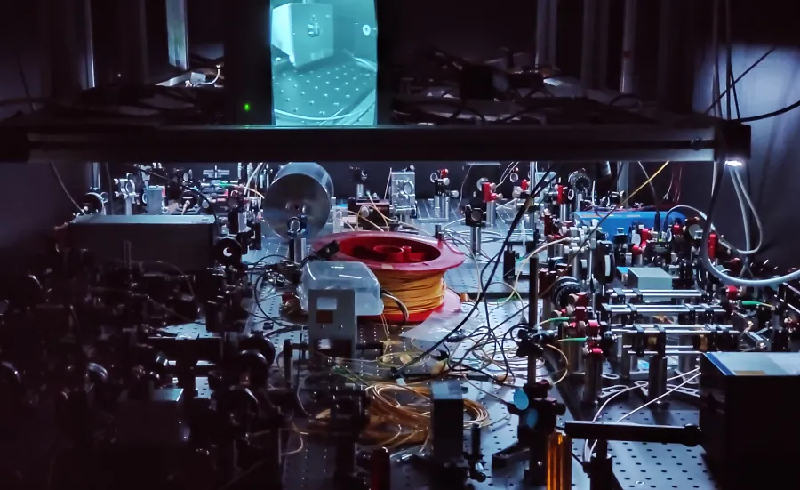 An optical table with components such as lasers, tapered amplifiers, optical fibers and various free-space optics and optomechanics. 