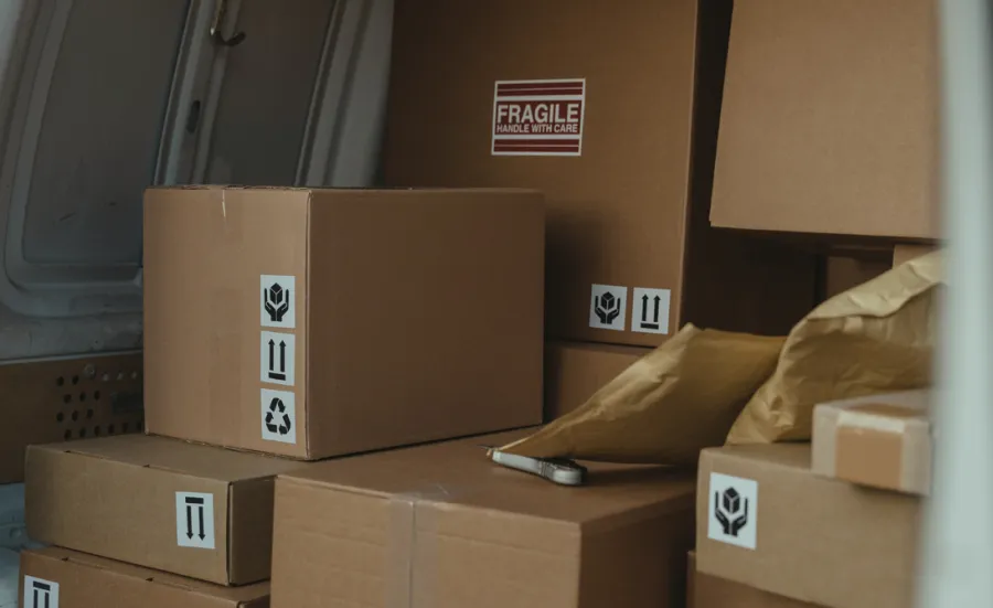 Pexels image of brown parcels stacked inside a delivery van