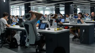 Workers in a digital technology company working in an open-plan office space