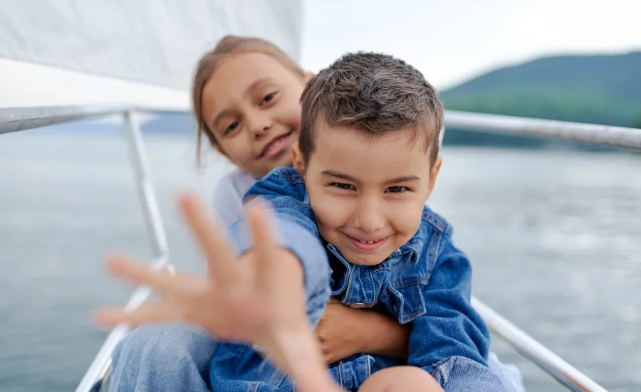 Close of two happy looking young children on a yacht