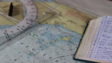 Nautical chart and a notebook on a table