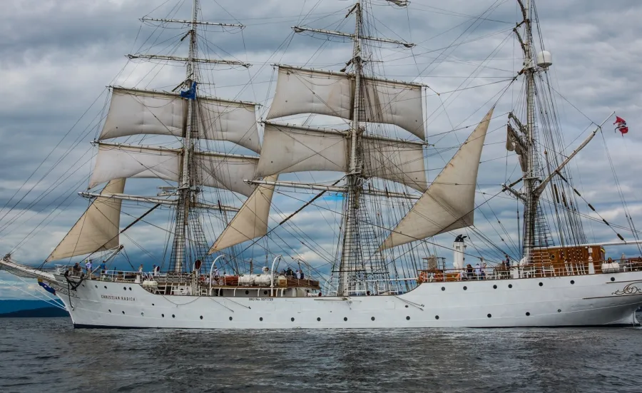 White three masts ship sailing near the shore