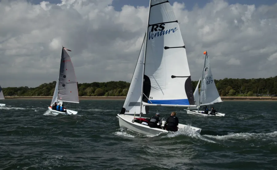 3 dinghies sailing along the coast