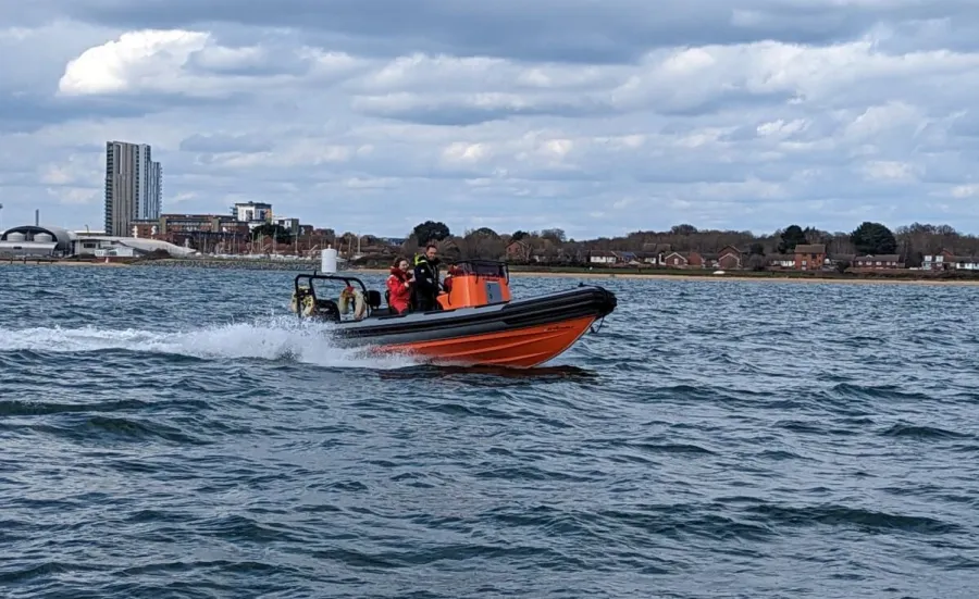 Powerboat with instructor and student out on the water