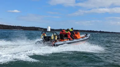 Powerboat moving away from the camera