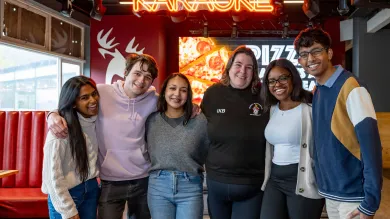 Group of smiling students in bar