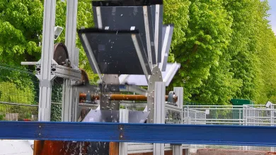 A modern water wheel on a small river