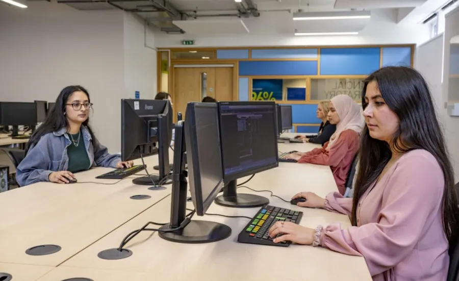 A group of economics students at work in the financial suite