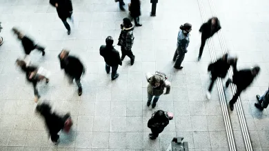 People walking along a busy city street, pictured from above