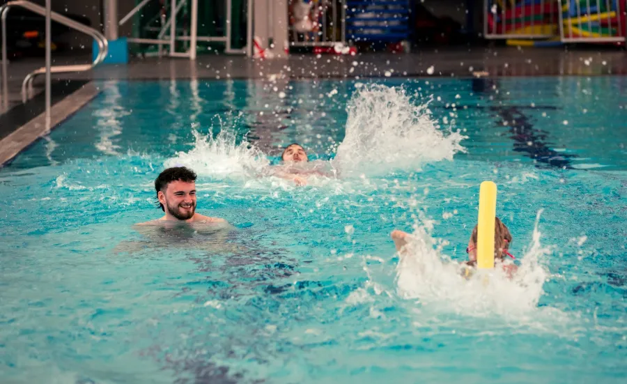 Three people in a swimming pool