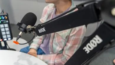 A person is making a voice recording using high-quality podcast microphones