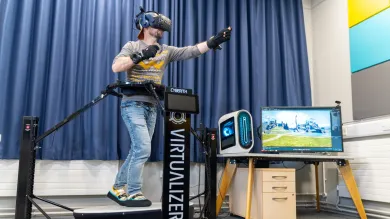 A person is using a VR treadmill to explore a virtual environment