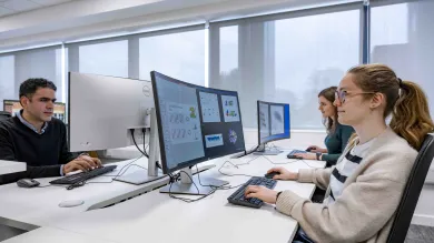 Students undertaking work at a computer station. 
