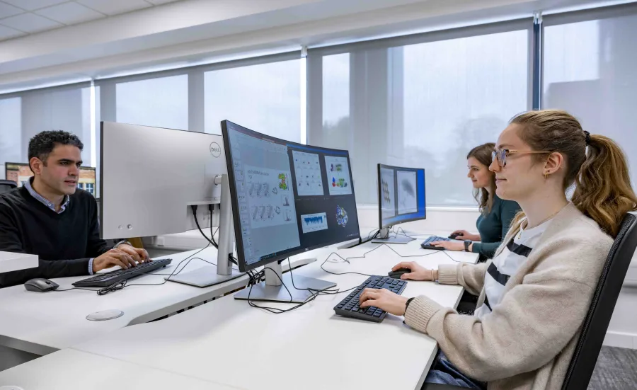 Students undertaking work at a computer station.