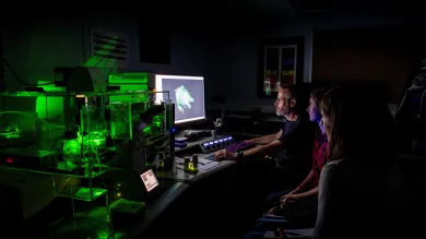 A group os scientists pour over the results of a confocal lightsheet microscopy image