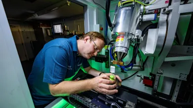 A scientist prepares a specimen to have its x-ray taken.