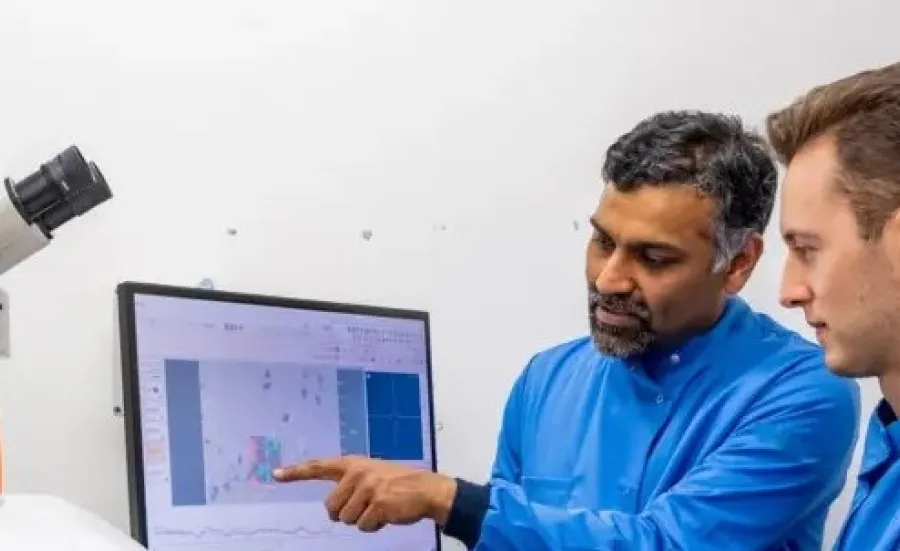 Professor Sumeet Mahajan and student at a computer