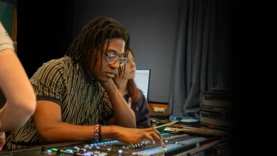 Young person working at mixing desk