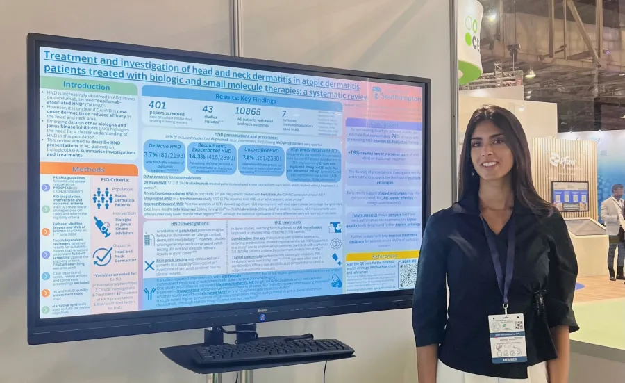 Hannah presenting her research in front of  a whiteboard