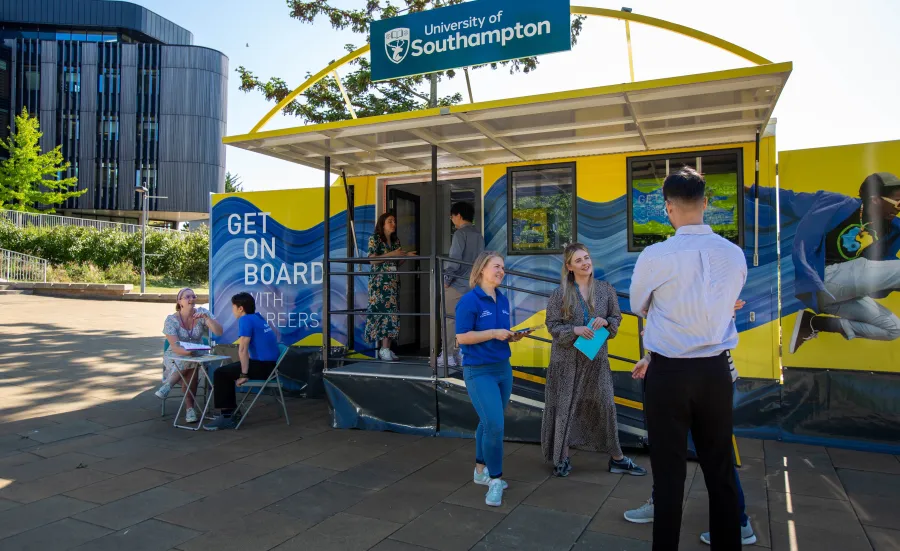 Careers staff talking with students at a University of Southampton outdoor stand.