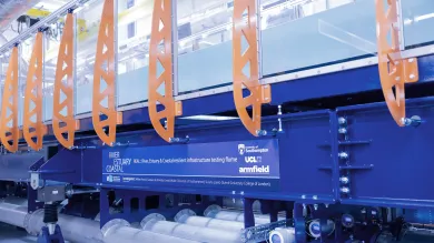 Industrial flume with blue frame and orange braces.
