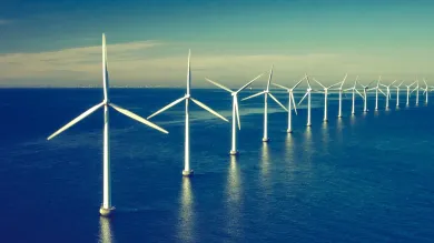 Offshore wind turbines in coastal waters, representing sustainable and resilient ocean engineering solutions