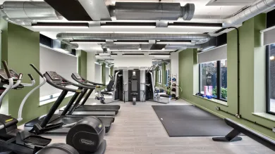 Capital House gym, featuring: treadmills, exercise mats, and strength training machines