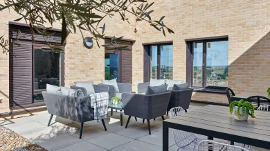 An outdoor seating area at Southampton Crossings. The area is a private patio with comfortable seating. 