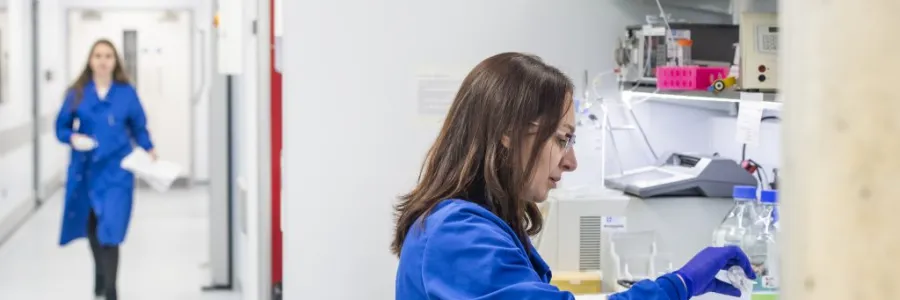 A researcher conducting work at a testing station within the centre for cancer immunology.