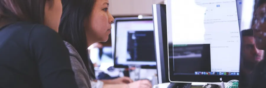 2 women looking at computer screens