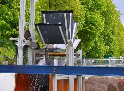 A modern water wheel on a small river