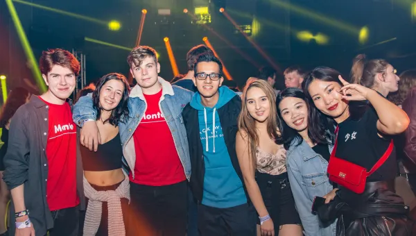 Group of happy fresher students at a nightclub.