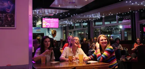 Group of students having fun at a SUSU event in the union bar.