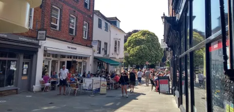 Restaurants with outdoor tables on a Winchester street. 