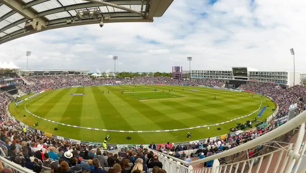 Wide view of Ageas Bowl stadium, with crowd watching cricket.